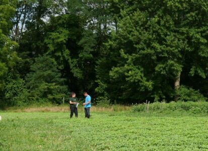 two researchers collecting soil samples