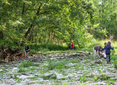 field trip of fourth graders exploring the creek at Greenacres Miami Township Clermont County
